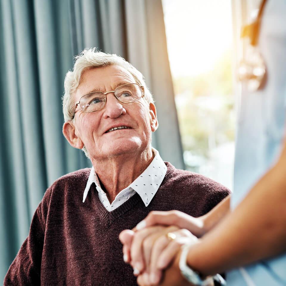 A man holding a doctor's hand